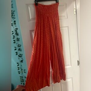 Out from under orange flowy pants